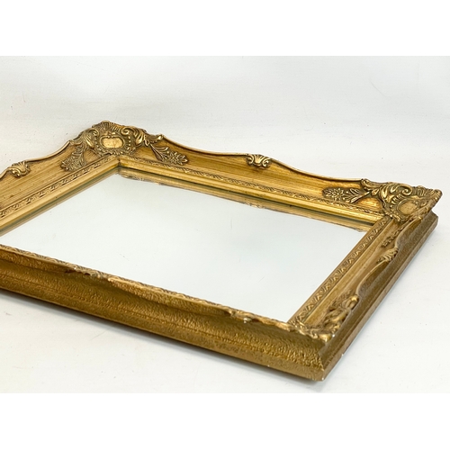 253 - An ornate gilt framed mirror. 34x39cm