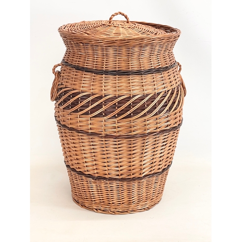 271 - A large good quality wicker linen hamper with handles and lid. 61cm