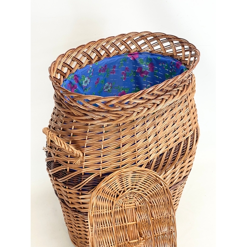 273 - A large good quality wicker linen hamper with handles and lid. 55x62cm