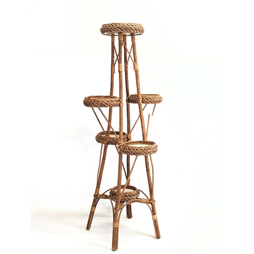 278 - A good quality tall wicker plant stand with wicker magazine rack. Plant stand measures 113cm