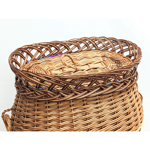 283 - A large good quality wicker linen hamper with handles and lid. 55x63cm