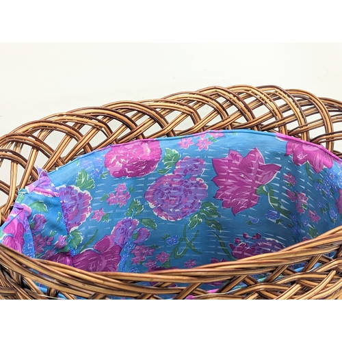 283 - A large good quality wicker linen hamper with handles and lid. 55x63cm