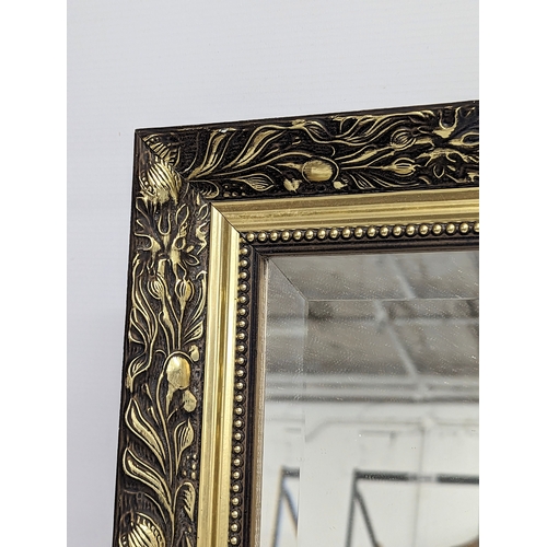 304 - A gilt framed mirror. 85.5x60.5cm