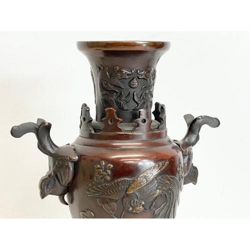 259 - A pair of late 19th century Japanese bronze vases. 24.5cm