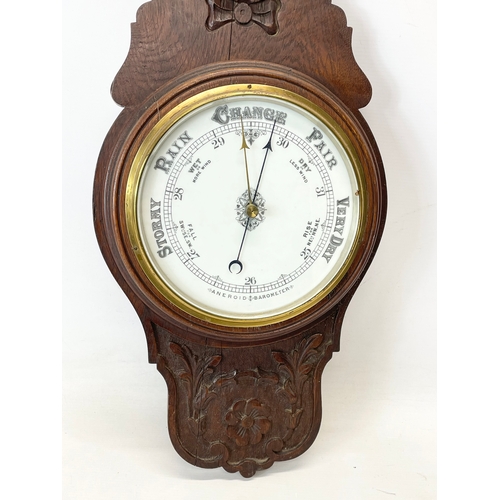 330 - A late Victorian carved oak barometer. 90cm