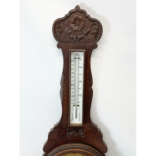 330 - A late Victorian carved oak barometer. 90cm