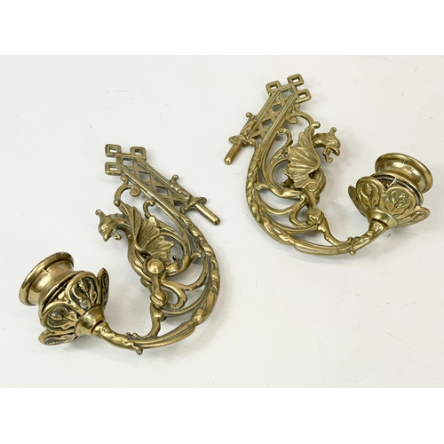 359 - A pair of ornate brass wall candle sconces with griffin decoration. 15cm