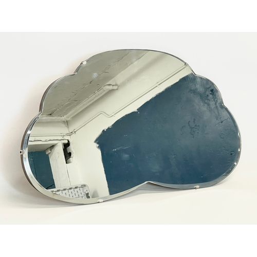 364 - An Art Deco bevelled mirror. 65x36cm