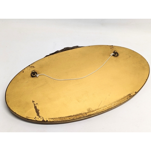 101A - An ornate gilt framed bevelled mirror. 63x37.5cm