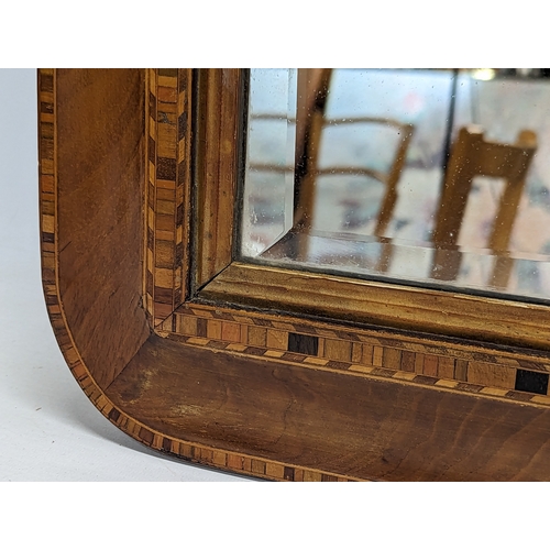 101C - A Victorian inlaid walnut bevelled mirror. 87x57cm