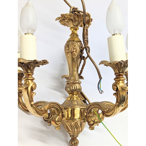 373D - A heavy ornate brass chandelier. 38.5x72.5cm