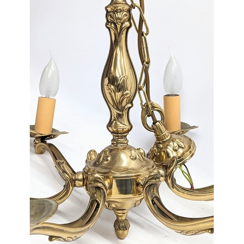 373E - A heavy brass ornate chandelier. 59x66cm