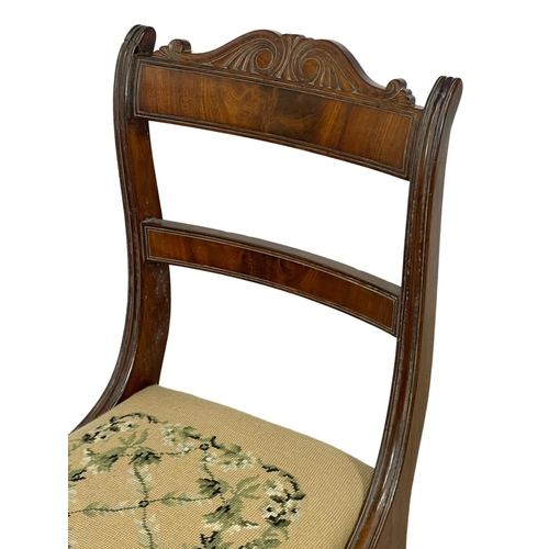 296 - A Regency mahogany side chair on sabre legs with tapestry seat. 1810.