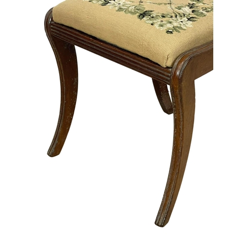 296 - A Regency mahogany side chair on sabre legs with tapestry seat. 1810.