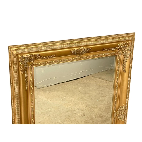 297 - A large ornate gilt framed mirror. 86x116cm