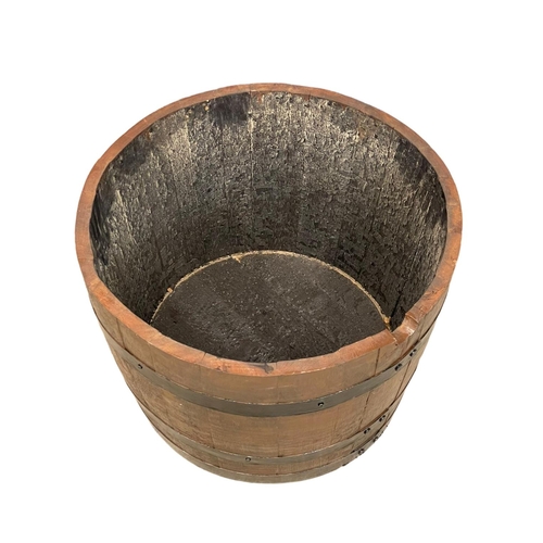 300 - A half barrel planter. 65x45cm