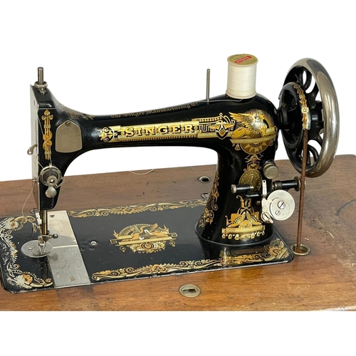 303 - A vintage Singer Sewing machine. 89x42x101cm