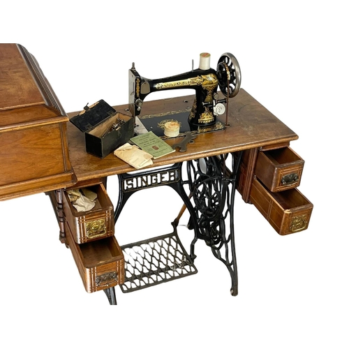 303 - A vintage Singer Sewing machine. 89x42x101cm