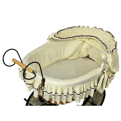 307 - A wicker pram with metal base. 102x104cm