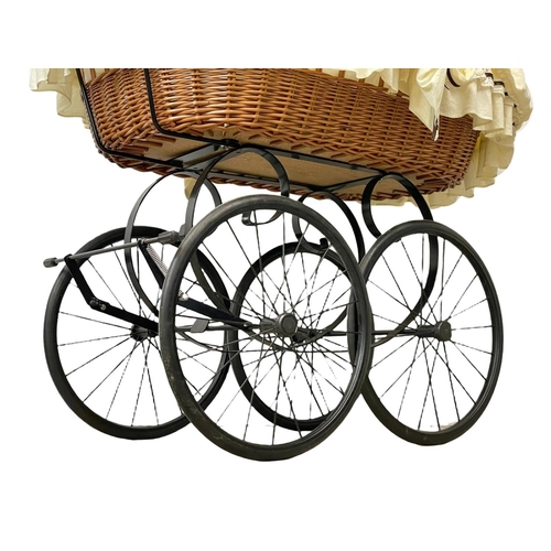 307 - A wicker pram with metal base. 102x104cm