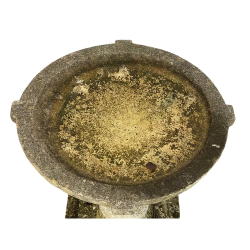 313 - A large concrete garden birdbath. 56x79cm