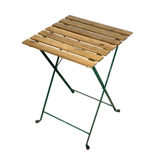 316 - A folding garden table and 2 chairs. Table measures 55x54x72cm