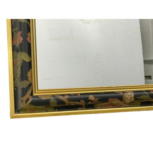 373T - An ornate gilt framed mirror. 73x104cm