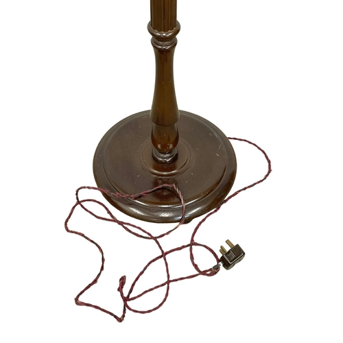 65 - A vintage mahogany standard lamp. 183cm