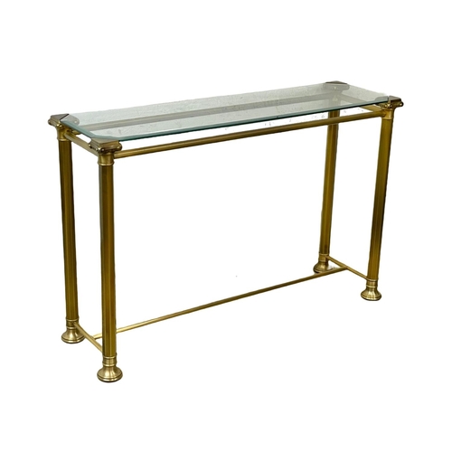 84 - A brass side table with glass top. 115x35x75cm