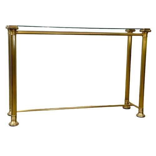 84 - A brass side table with glass top. 115x35x75cm