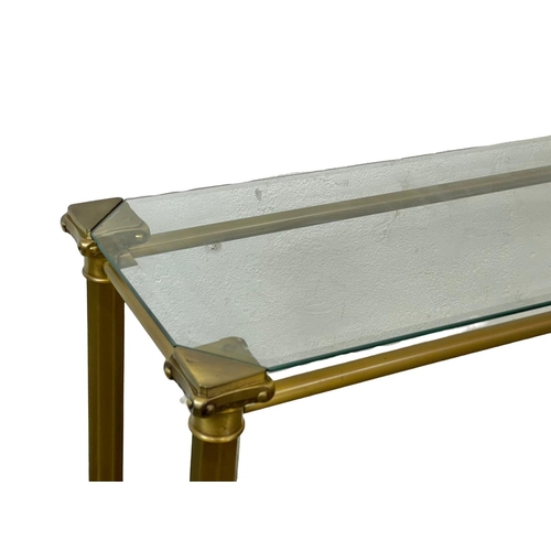 84 - A brass side table with glass top. 115x35x75cm