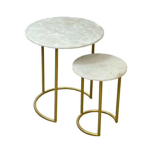 85 - A nest of tables with marble tops and brass frame.