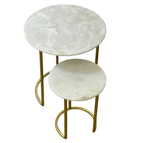 85 - A nest of tables with marble tops and brass frame.