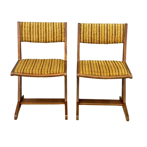 891 - A set of 4 Mid Century teak dining chairs with original upholstery.