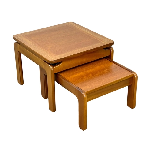 894 - A large Mid Century teak nest of tables. 60x60x44cm