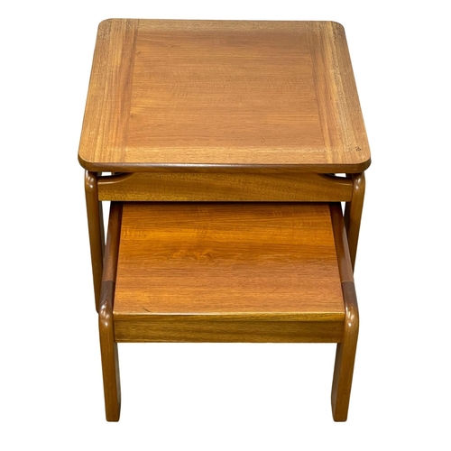 894 - A large Mid Century teak nest of tables. 60x60x44cm