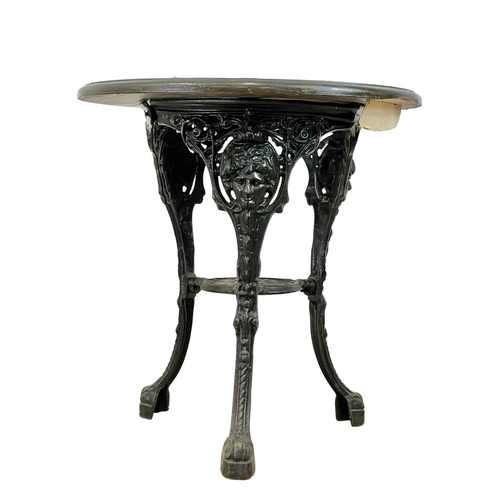 911 - A vintage cast iron base garden table. 68x70cm