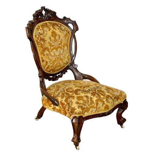 915 - A Victorian carved mahogany ladies nursing chair.