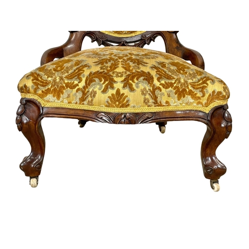 915 - A Victorian carved mahogany ladies nursing chair.