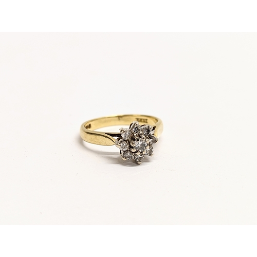 609 - An 18ct gold diamond cluster ring. Size K