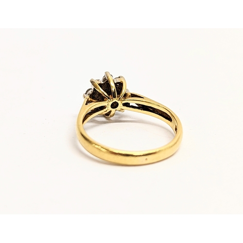 609 - An 18ct gold diamond cluster ring. Size K