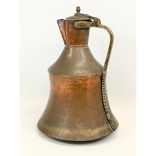 617 - A large vintage Indian copper jug. 44cm