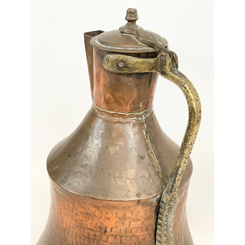 617 - A large vintage Indian copper jug. 44cm