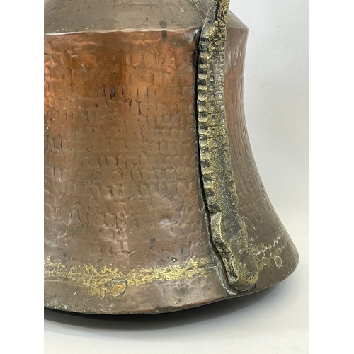 617 - A large vintage Indian copper jug. 44cm