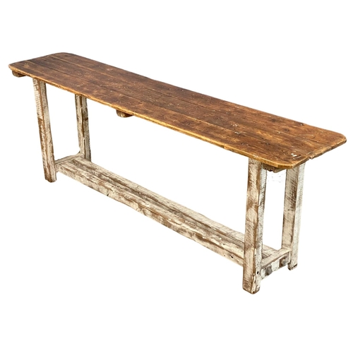 907 - A large early 20th century pine industrial console table. 240x51x83cm