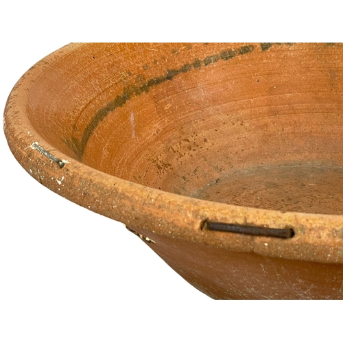 389T - A very large late 19th century French terracotta dough bowl. 71x22cm