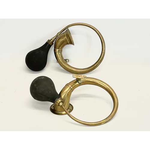 12 - A pair of vintage brass car horns. 34cm