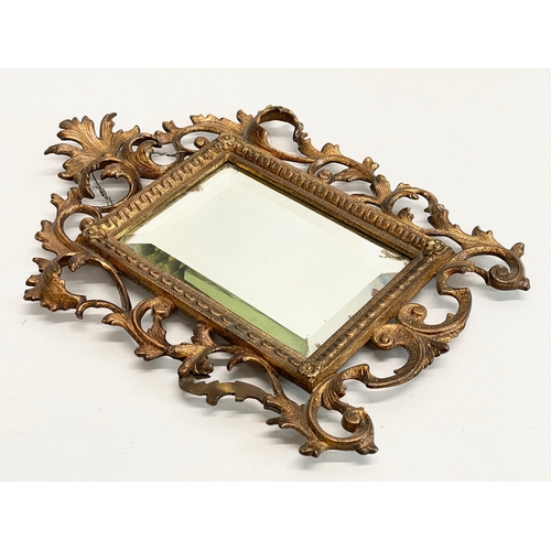 14 - A pair of late Victorian ornate brass mirrors in the Rococo style. 22x30cm