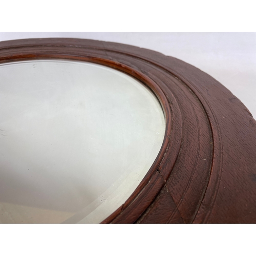 17 - An Edwardian oak framed spinning wheel mirror. 50cm