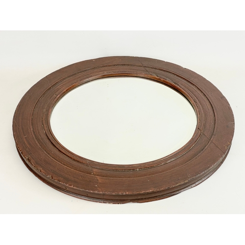 17 - An Edwardian oak framed spinning wheel mirror. 50cm